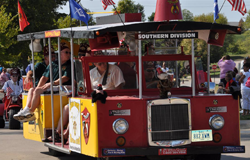 Yellow trolley with flags and Shriners decals